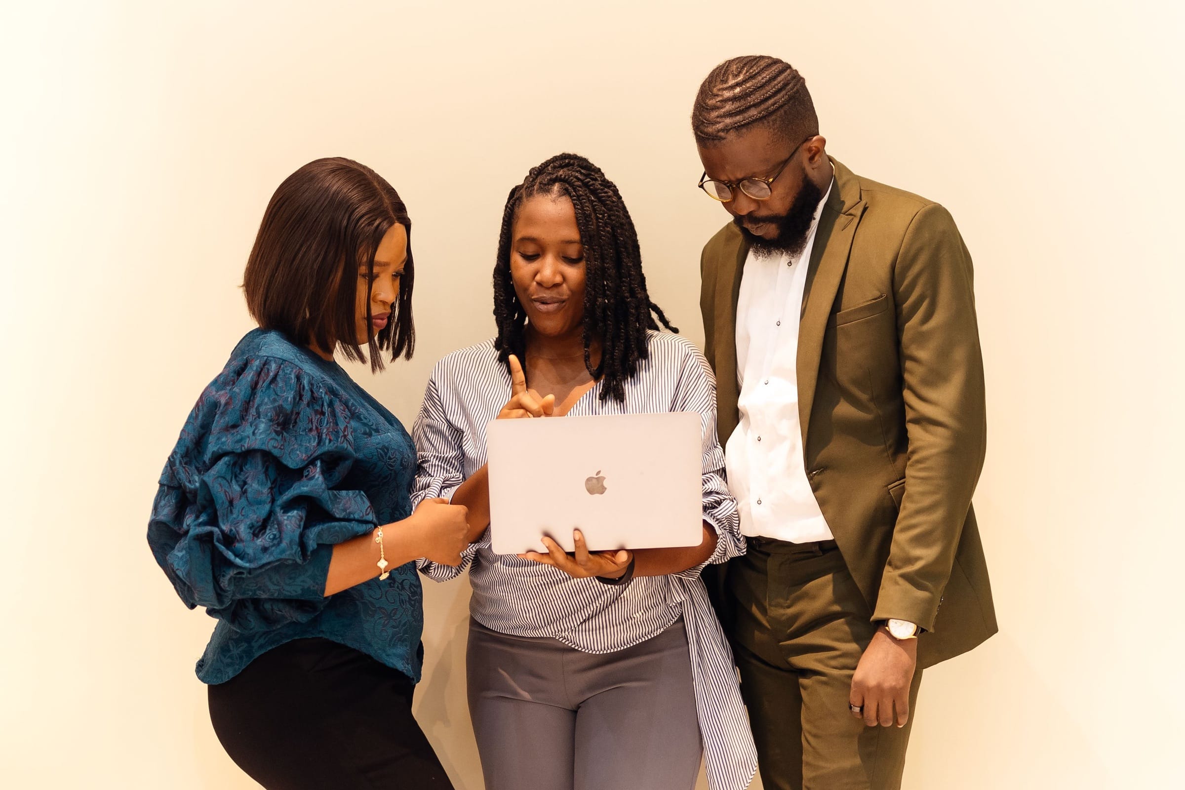 African technology professionals collaborating around a laptop